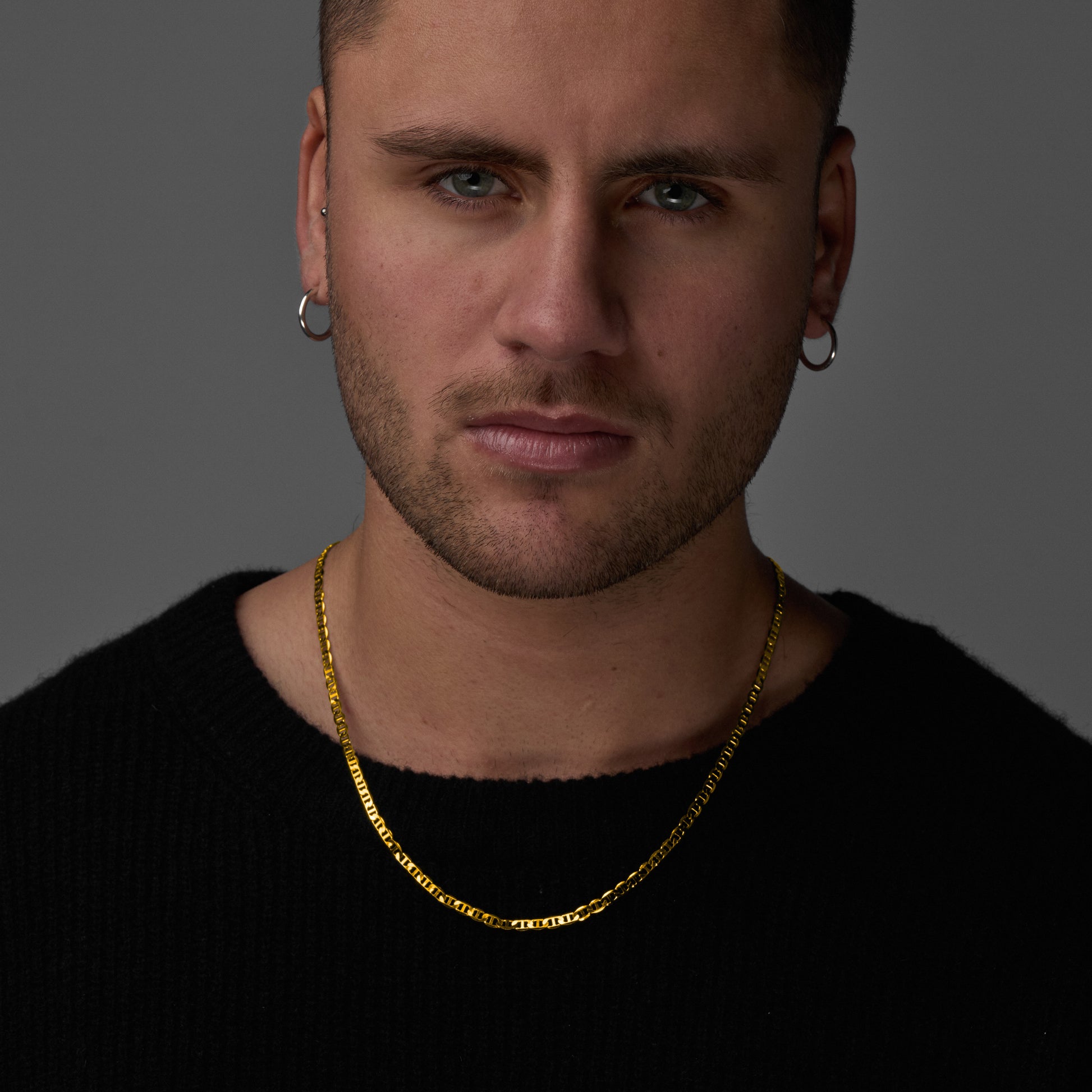 A man wearing and showcasing Infinite Necklace