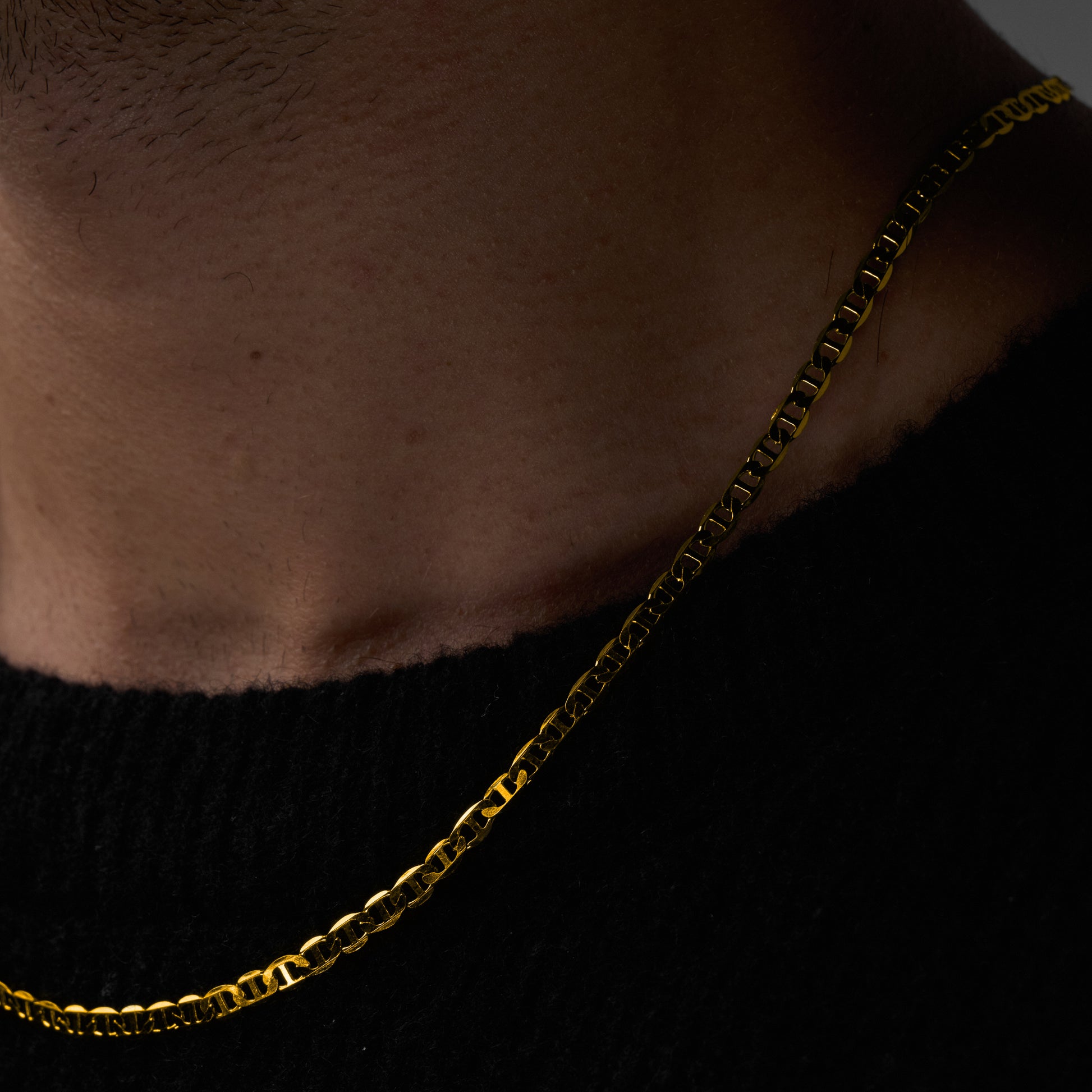 A man wearing and showcasing Infinite Necklace close up