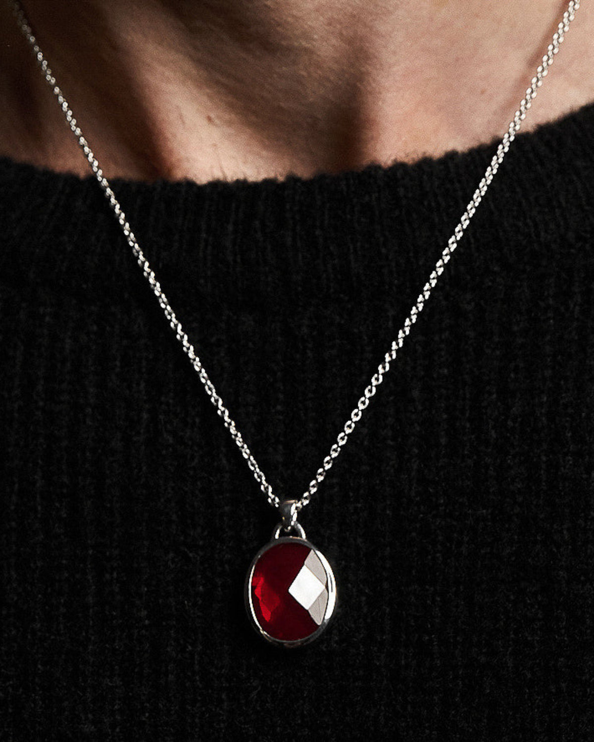 Model wearing the Suki Red Garnet Pendant handcrafted from solid 925 sterling silver on a sterling silver necklace.